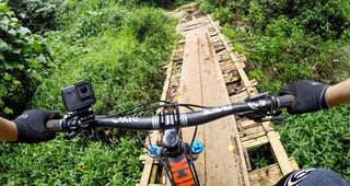 A GoPro camera mounted on a Handlebar using a pole mount as seen from the cyclist's POV