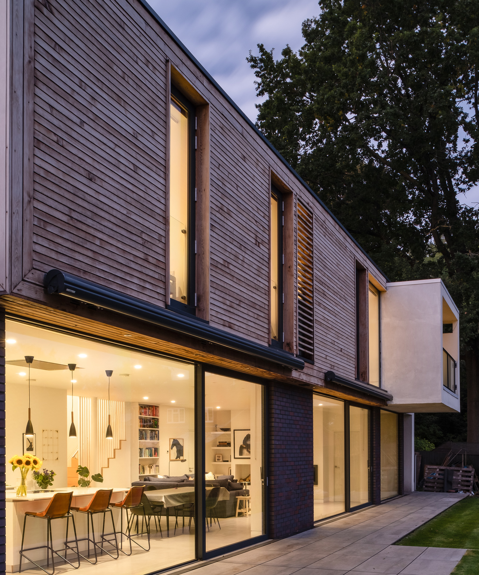 The exterior of a two storey contemporary self build home at dusk