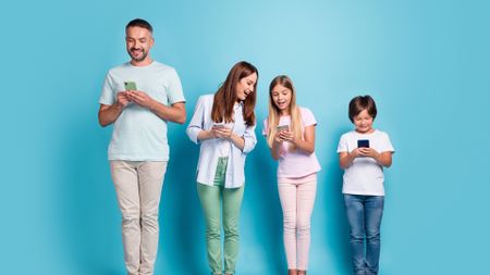 family of four enjoying their smartphones against a light blue gradient background
