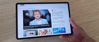 Hand holding Honor Pad 10 tablet showing Creative Bloq homepage