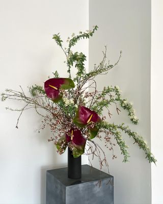 a fresh flower arrangement on a gray pedestal