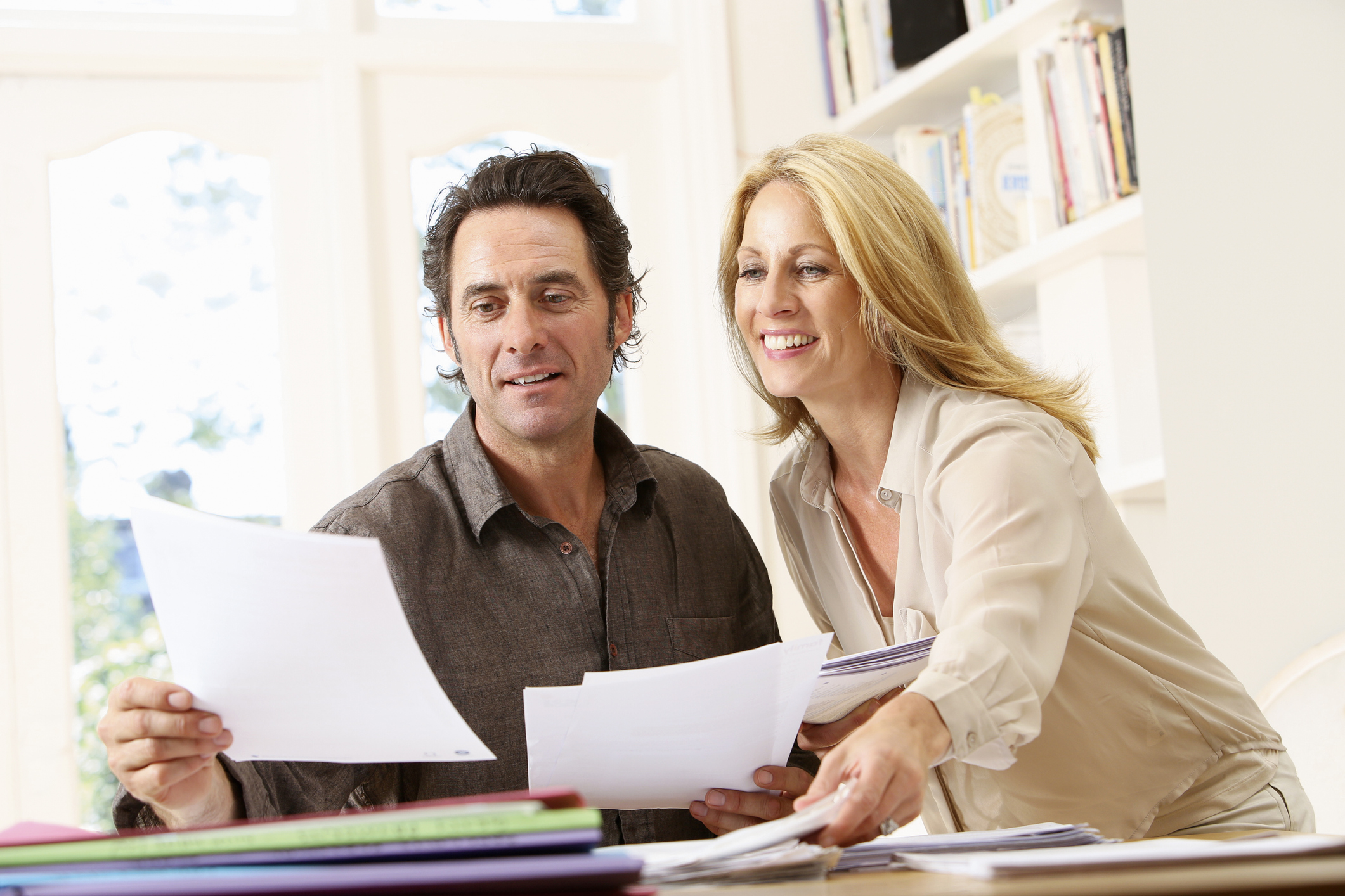 a couple reviewing financial docs