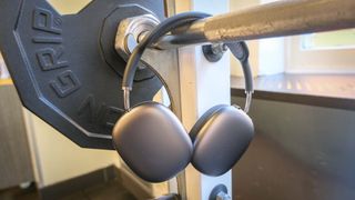 Apple AirPods Max at the gym hanging on a barbell