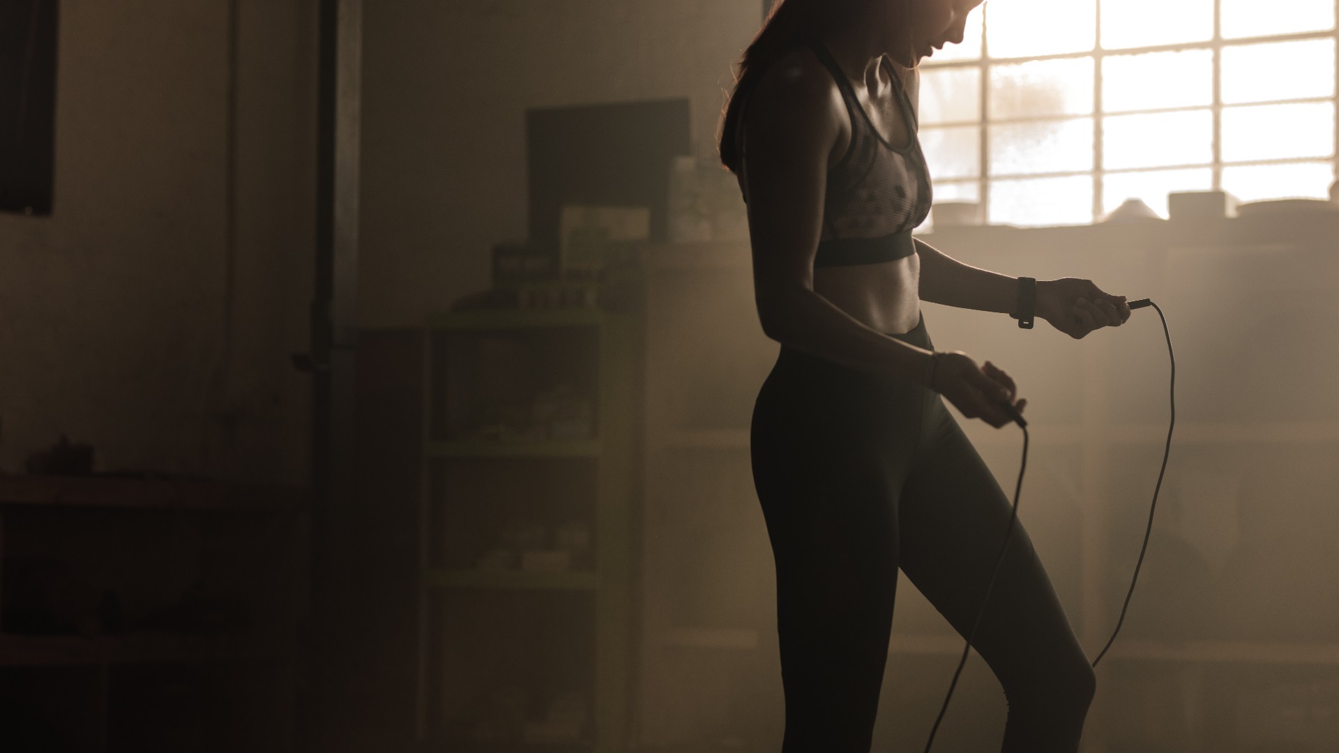 Woman holding a jump rope ready to start her workout