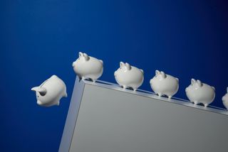 Piggy banks falling off a cliff