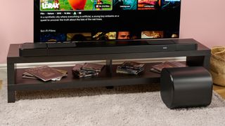 JBL Bar 1300MK2 soundbar surround speakers and sub alongside TV setup