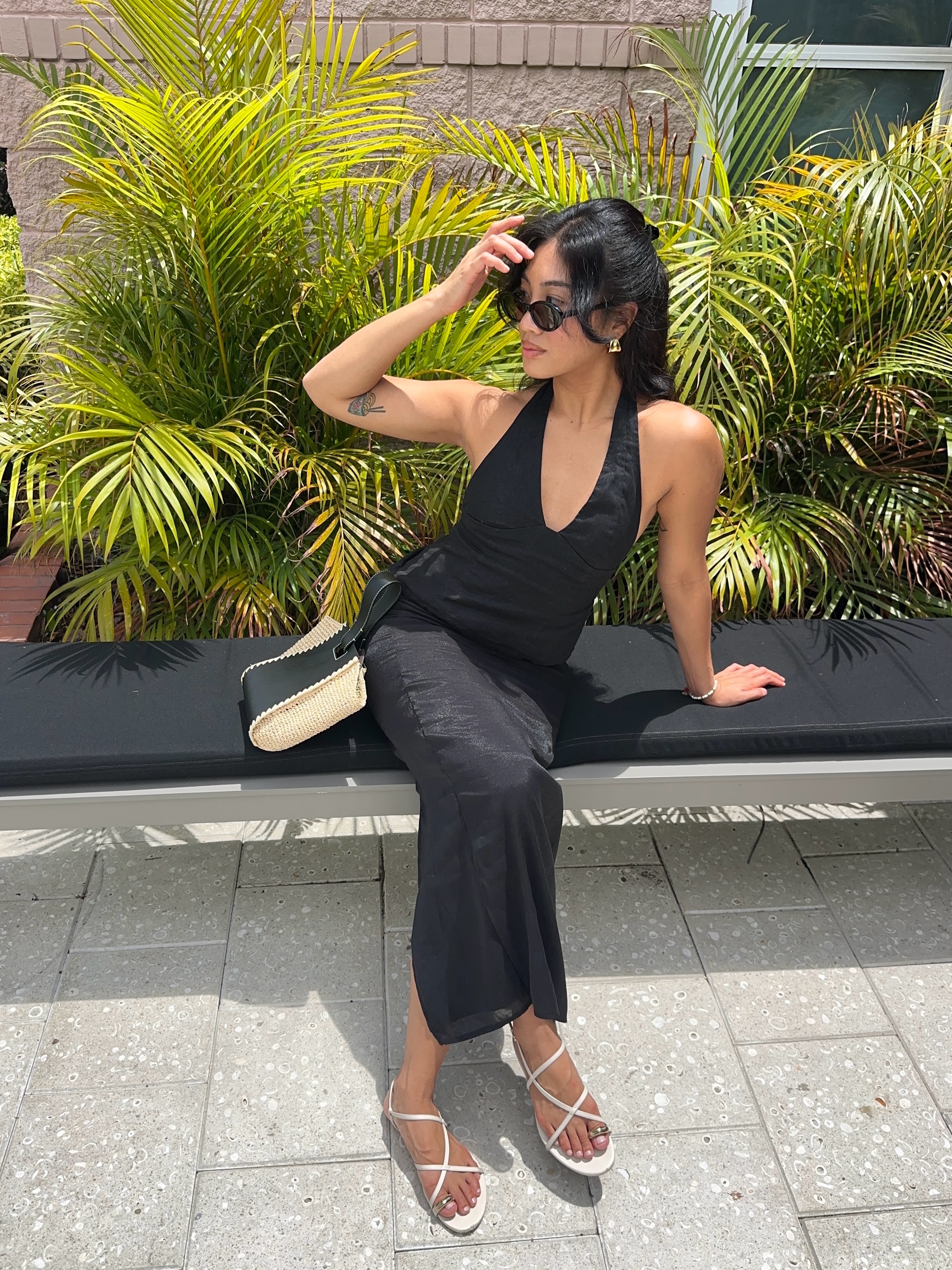 jeannine roxas wears a black maxi dress and toe ring sandals