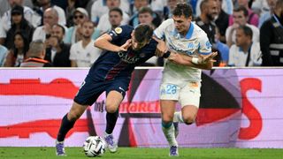 PSG's Khvicha Kvaratskhelia vies with Marseille's Benjamin Pavard