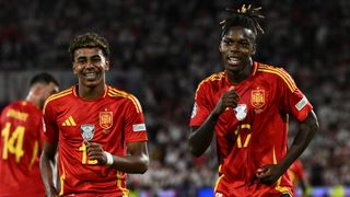 Lamine Yamal (L) and Nico Williams (R) dance a goal celebration in red shirts at Euro 2024.