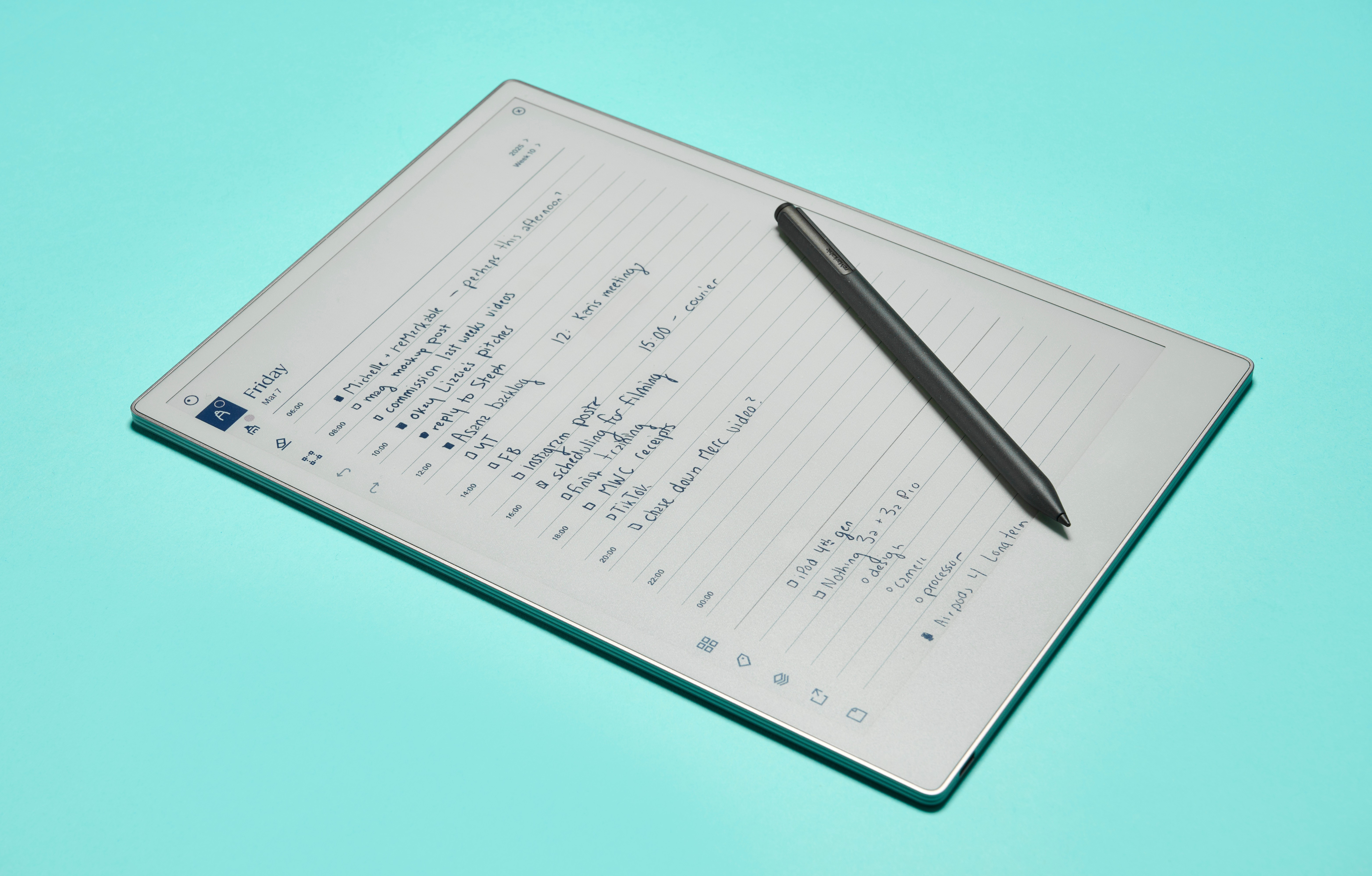 The ReMarkable Paper Pro lying on a light blue background, text on the screen and the Marker Plus lying diagonally across it.