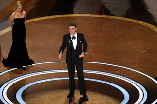 Peter Straughan accepts the award for Best Adapted Screenplay at the 2025 Oscars