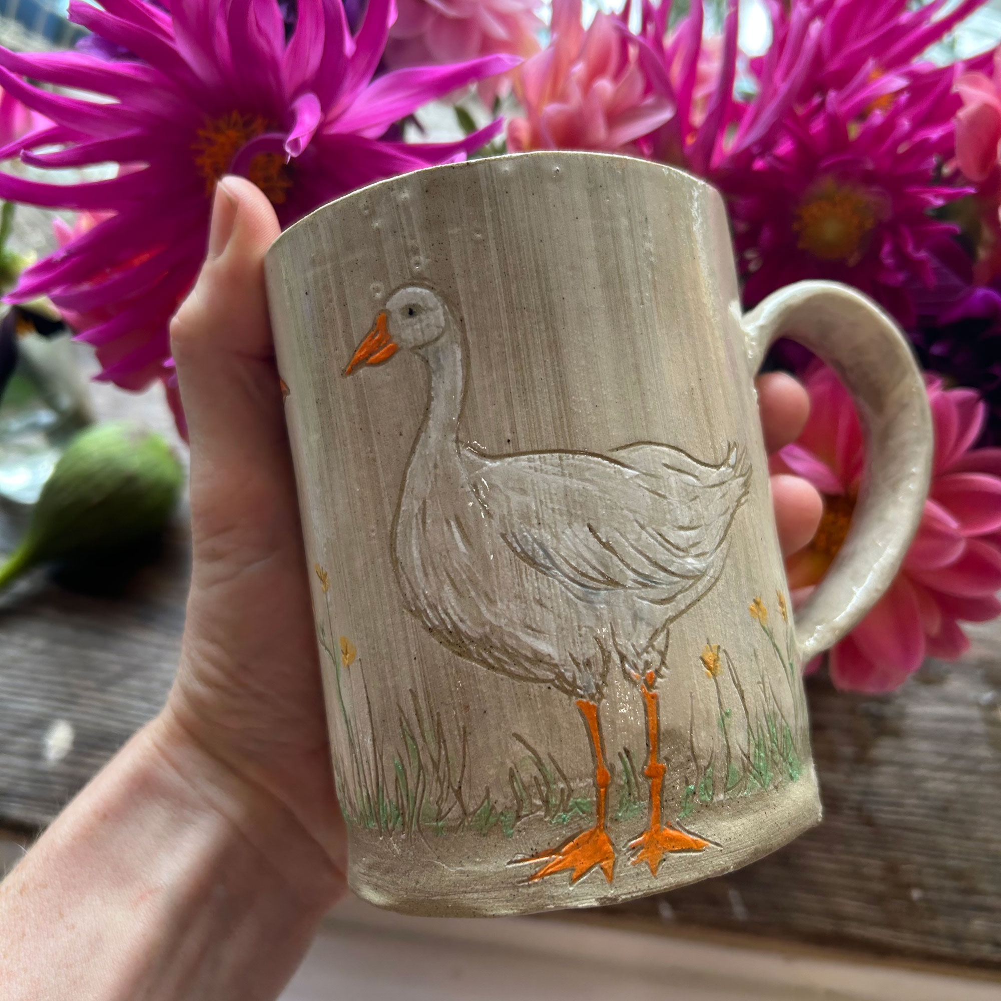 Person holding mug with duck design