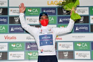 LAGOS PORTUGAL FEBRUARY 16 Remco Evenepoel of Belgium and Team QuickStep Alpha Vinyl celebrates winning the white best young jersey on the podium ceremony after the 48th Volta Ao Algarve 2021 Stage 1 a 1991km at stage from Portimo to Lagos VAlgarve2022 on February 16 2022 in Lagos Portugal Photo by Luc ClaessenGetty Images