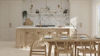 pale coloured fitted kitchen with 3 hanging gold pendant lights plus wooden dining table and chairs