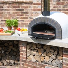 Outdoor pizza oven in outdoor kitchen