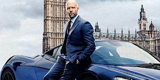 Hobbs & Shaw Deckard Shaw leaning against a Mclaren sport car in front of Parliament
