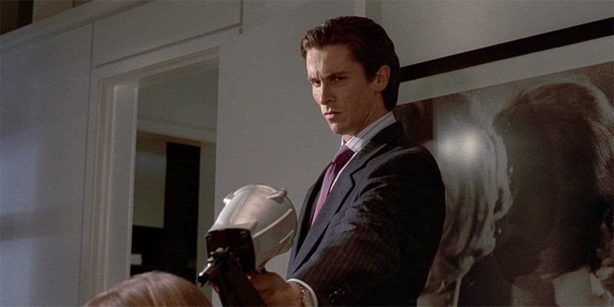 American Psycho Christian Bale holding a nail gun.