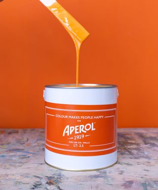 Tin of Aperol orange colored paint