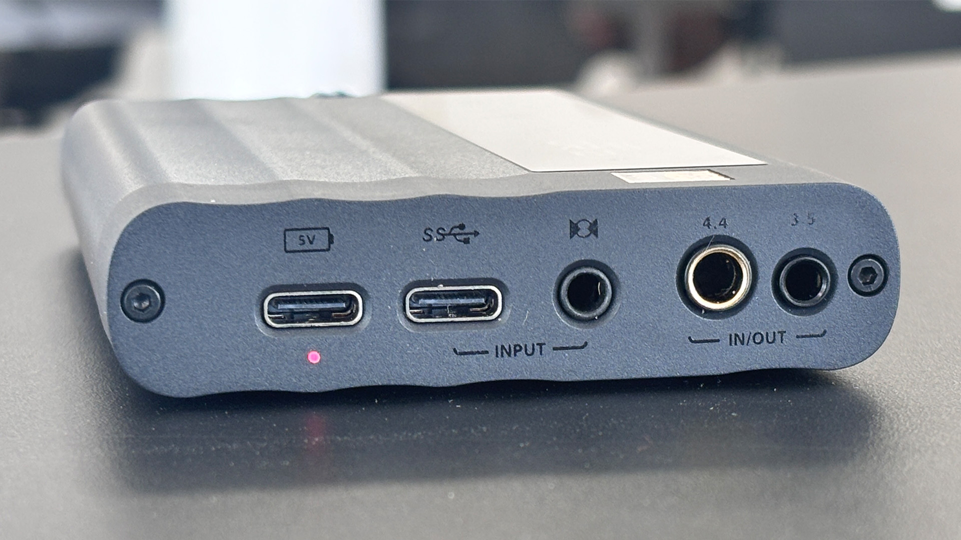 iFi iDSD GR 2 DAC on grey desk, rear of unit showing connections