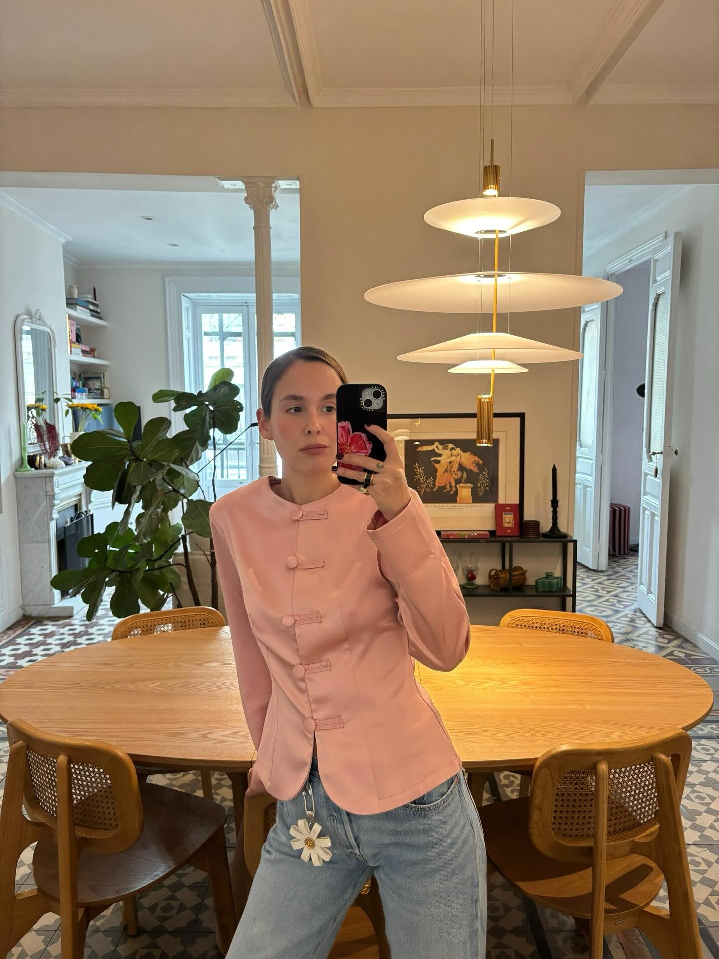 Woman in pale pink blazer and jeans