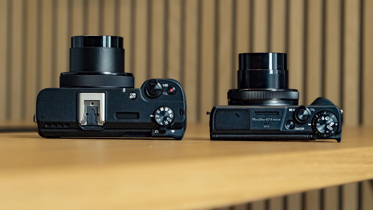 Canon PowerShot V1 compact vlogging camera on a wooden desk alongside the PowerShot G7X Mark III