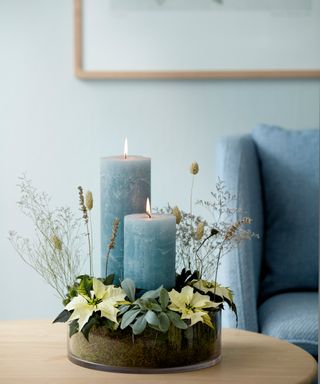 Poinsettia bracts used in a blue-themed Christmas centerpiece