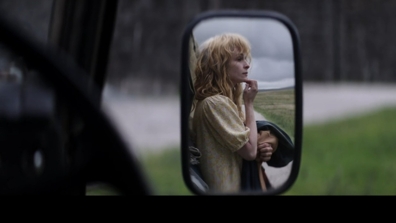 Ashleigh Cummings in a rearview mirror in The Beast Within.