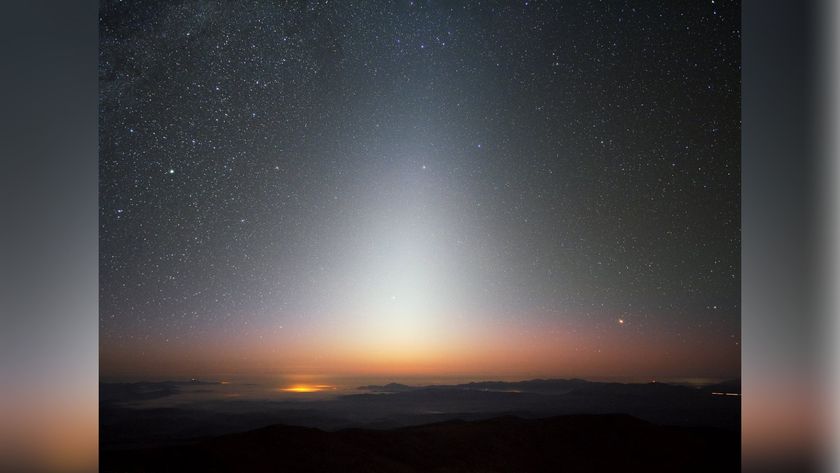 The image captures a zodiacal light, a triangular glow seen in the night sky.