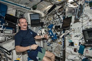 Astronaut Chris Hadfield using a cardio lab at the ISS.