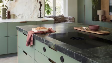 a back leathered kitchen countertop in a light green kitchen