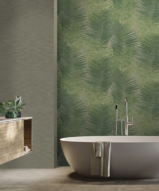 palm tree frond printed wallpaper behind modern free standing bath