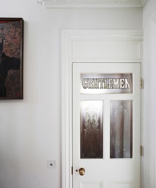 white door with gentlemans toilet silver sign