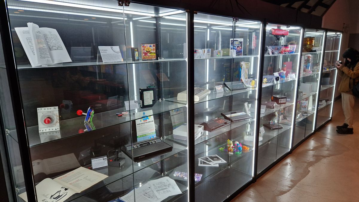 A glass display cabinet at the NVM showcasing parts of video game history