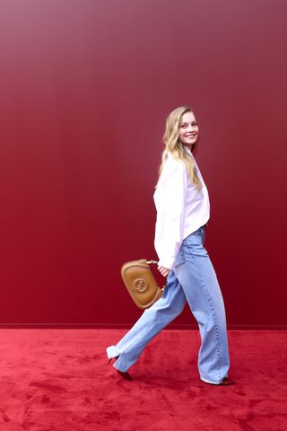 Hannah Dodd attends the Gucci Spring 2025 show carrying a Gucci Blondie Bag