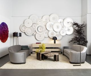 room set with cream rug two gray sofas stacking marble coffee table and wall art installations