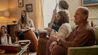 Jonathan Rumie and Kelsey Grammer sit on a couch in Jesus Revolution
