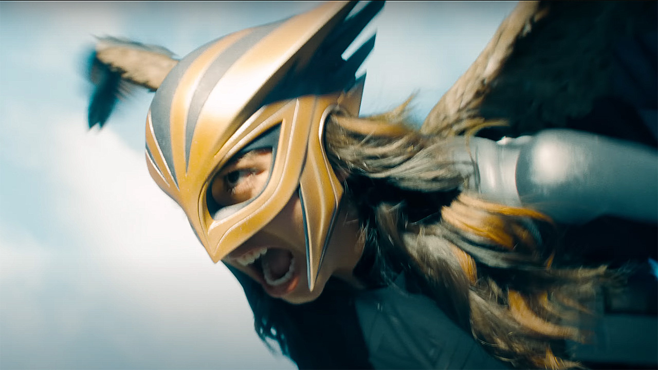 A close up of Hawkgirl flying and shouting in Superman