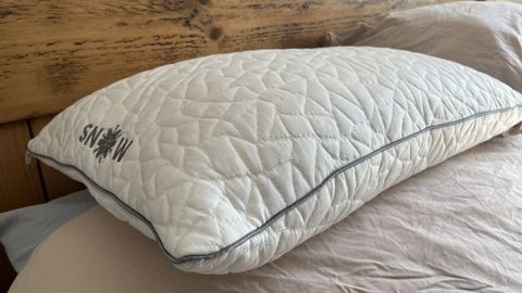 rem fit snow pillow on a bed