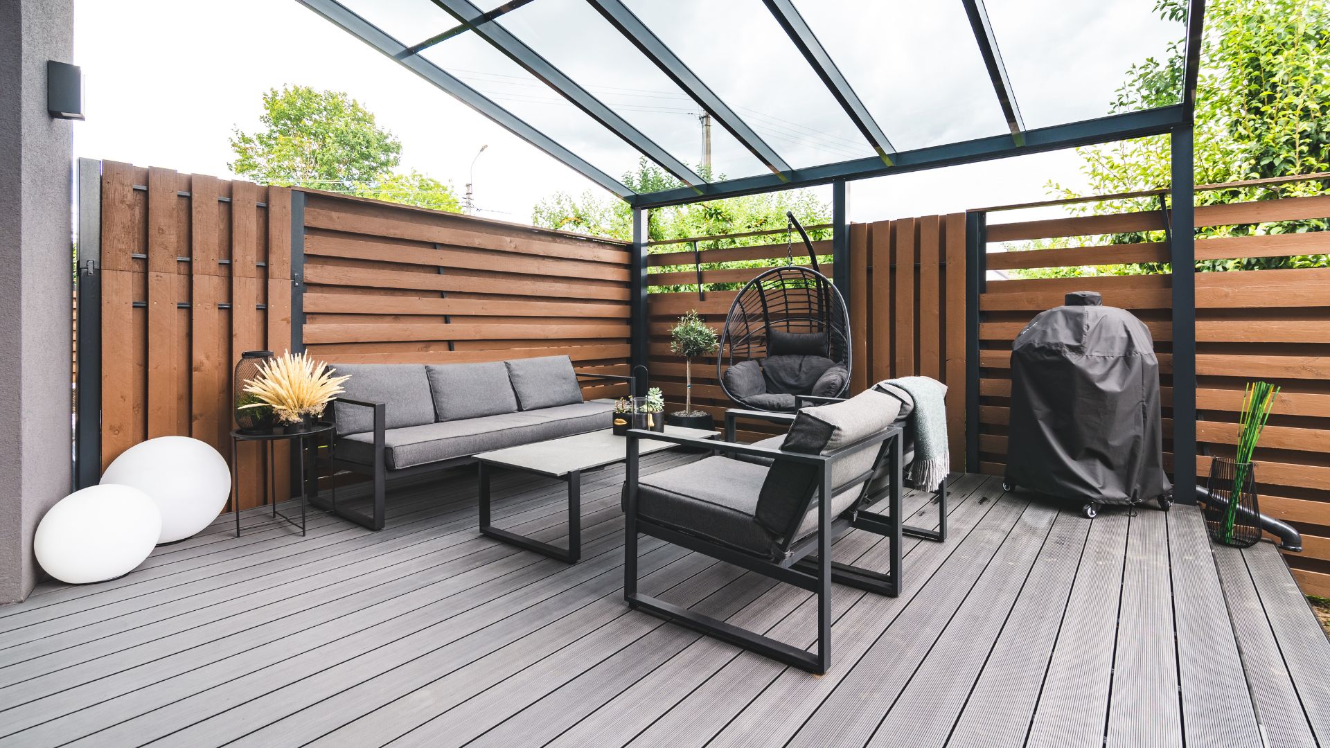 picture of grey decking and black garden furniture