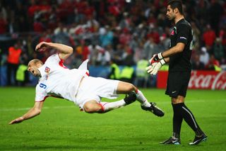 Turkey goalkeeper Volkan Demirel pushes Czech Republic forward Jan Koller to the ground in a group game at Euro 2008.