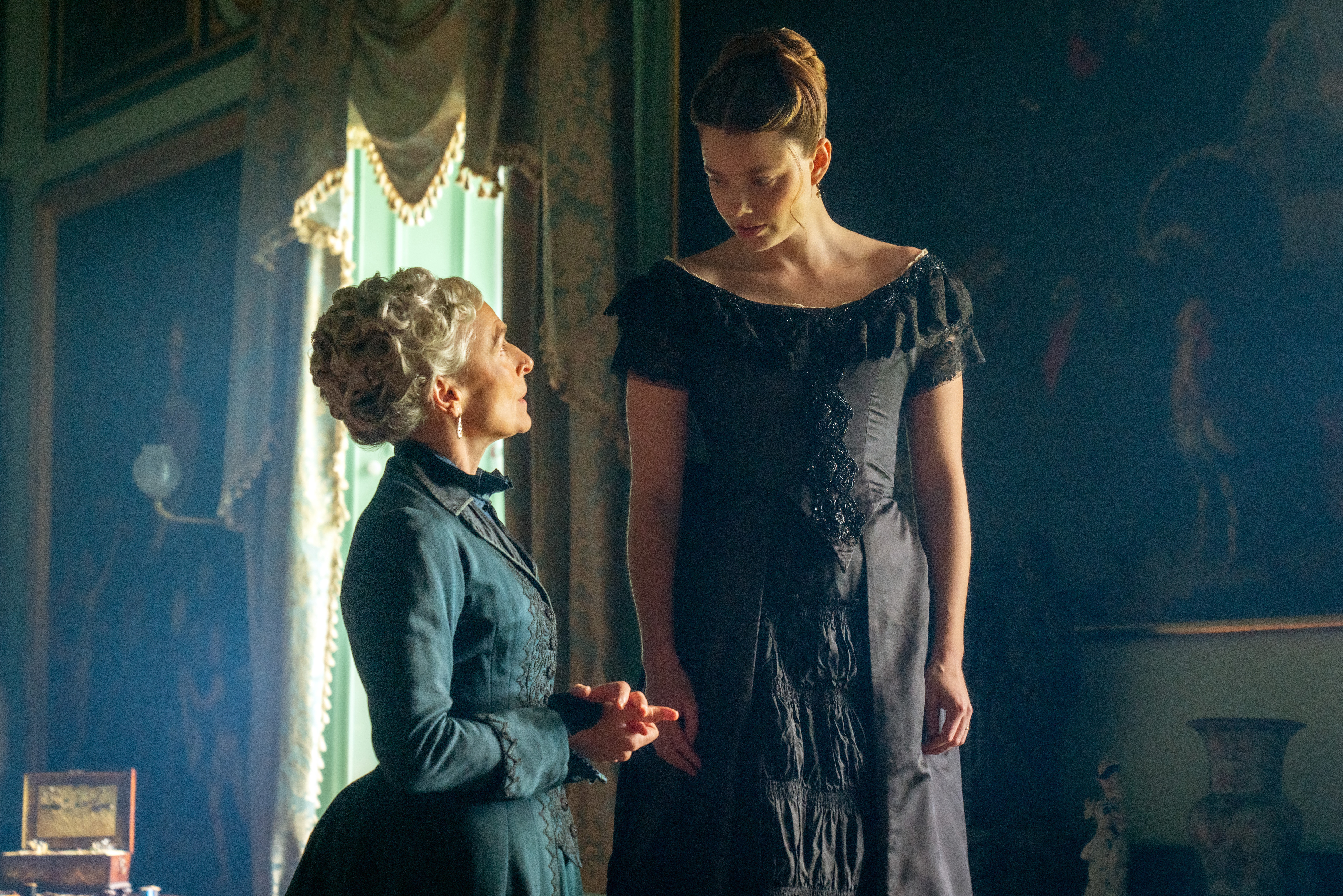Amelia Bullmore and Kristine Frøseth in The Buccaneers season 2 having a conversation in a parlor