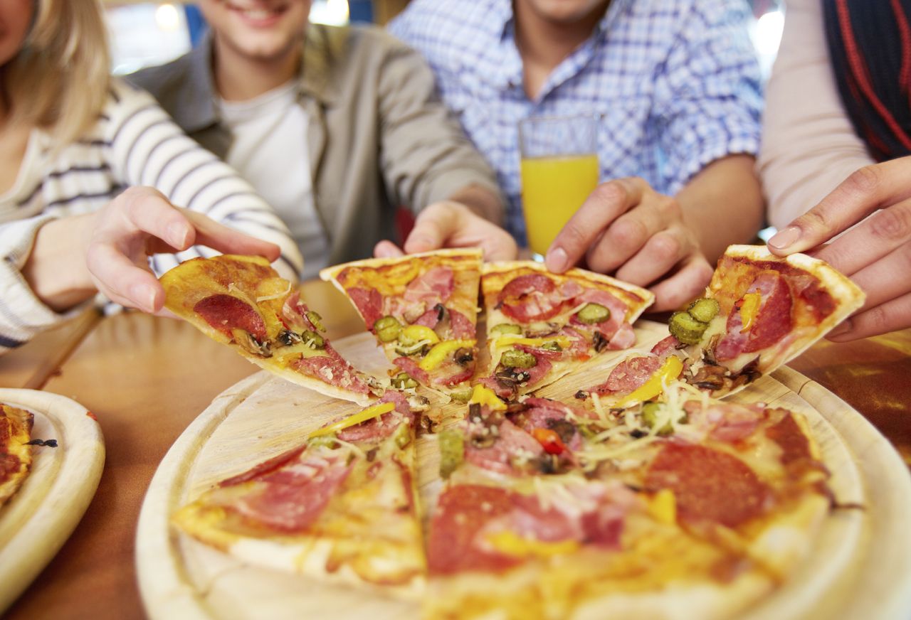 Young adults sharing a pizza