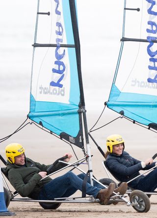Prince William and Kate Middleton racing on the beach