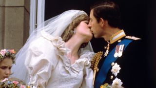 The newly married Prince and Princess of Wales (formerly Lady Diana Spencer) kiss on the balcony of Buckingham Palace after their wedding ceremony at St. Paul's cathedral.