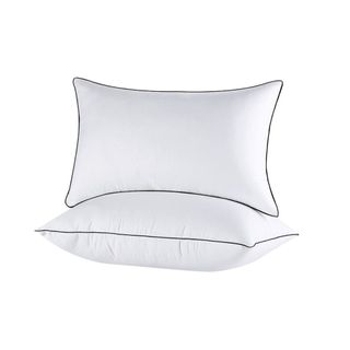 Two white pillows with black piping