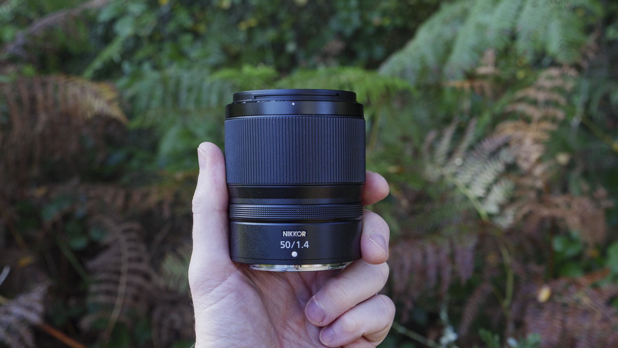 Nikon Z 50mm f/1.4 lens in the hand