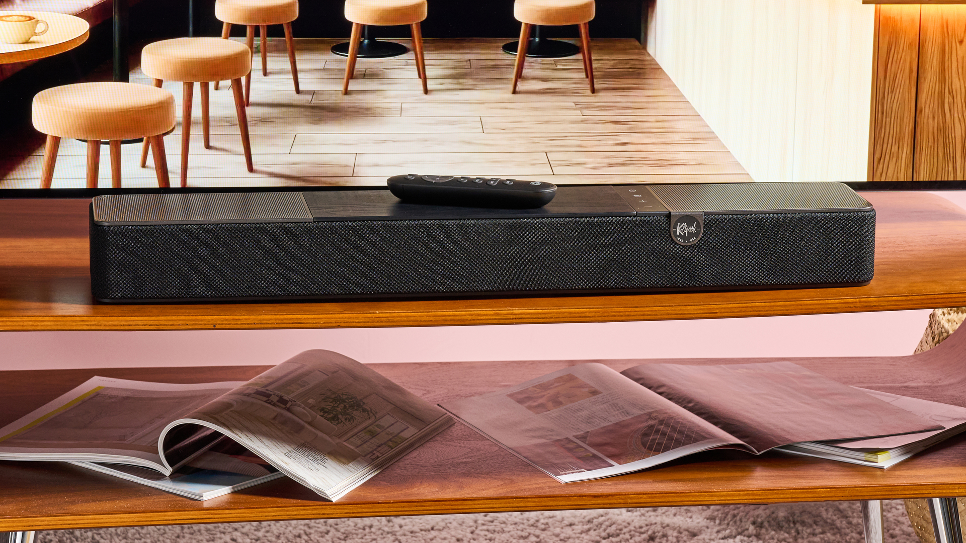 Klipsch Flexus Core 100 under TV with magazines on table
