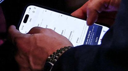 Former National Security Adviser Mike Waltz is seen using the TeleMessage app during a White House cabinet meeting.