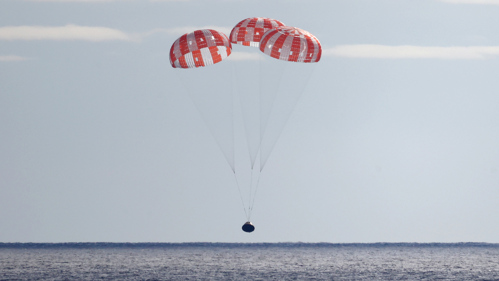The Orion capsule of Artemis I landing in the ocean