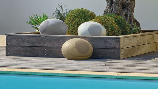 Three Focal Littora Stone 8 speakers outside, beside a pool and a tree